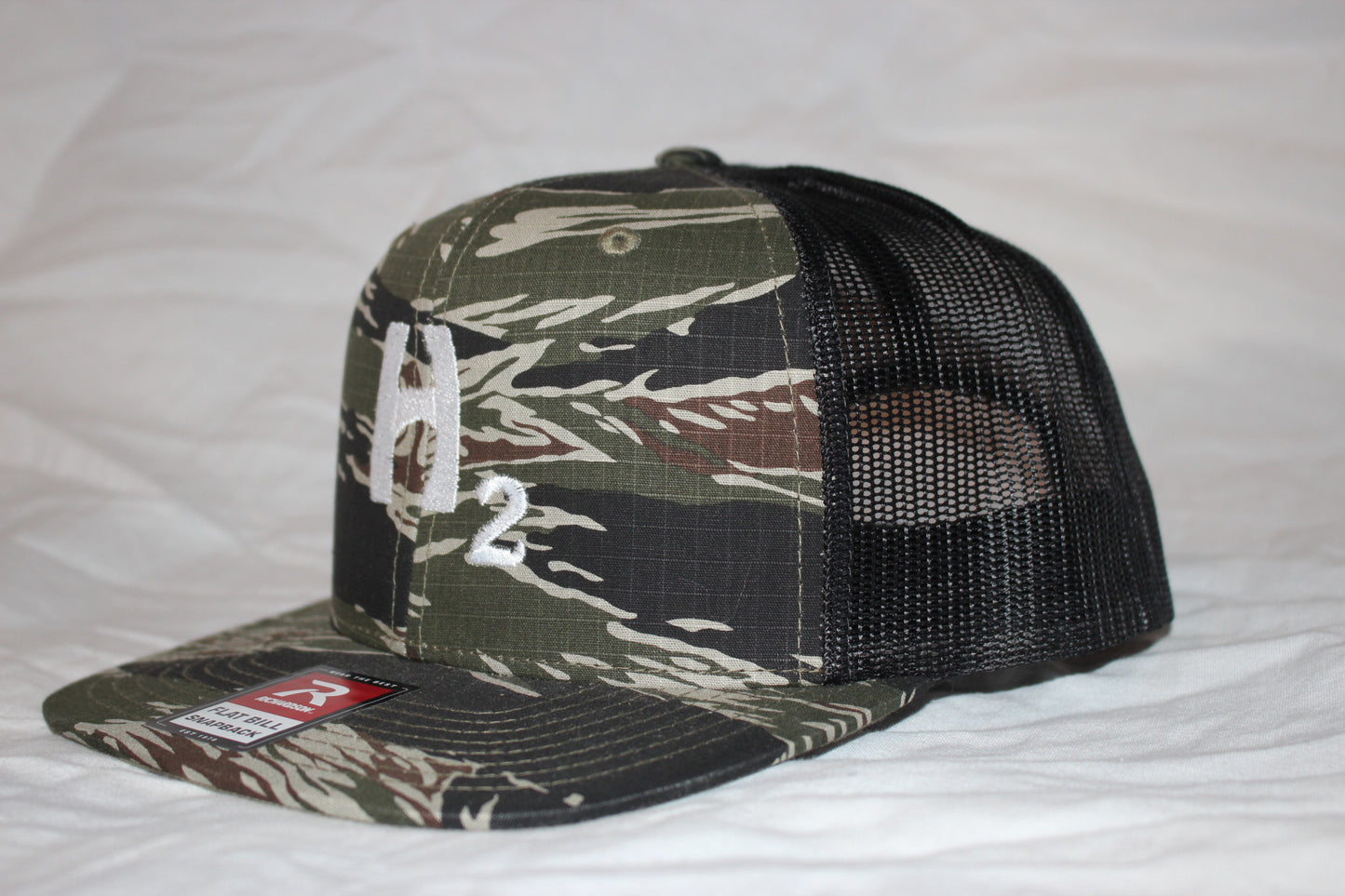 Hebert Camo and White Snapback